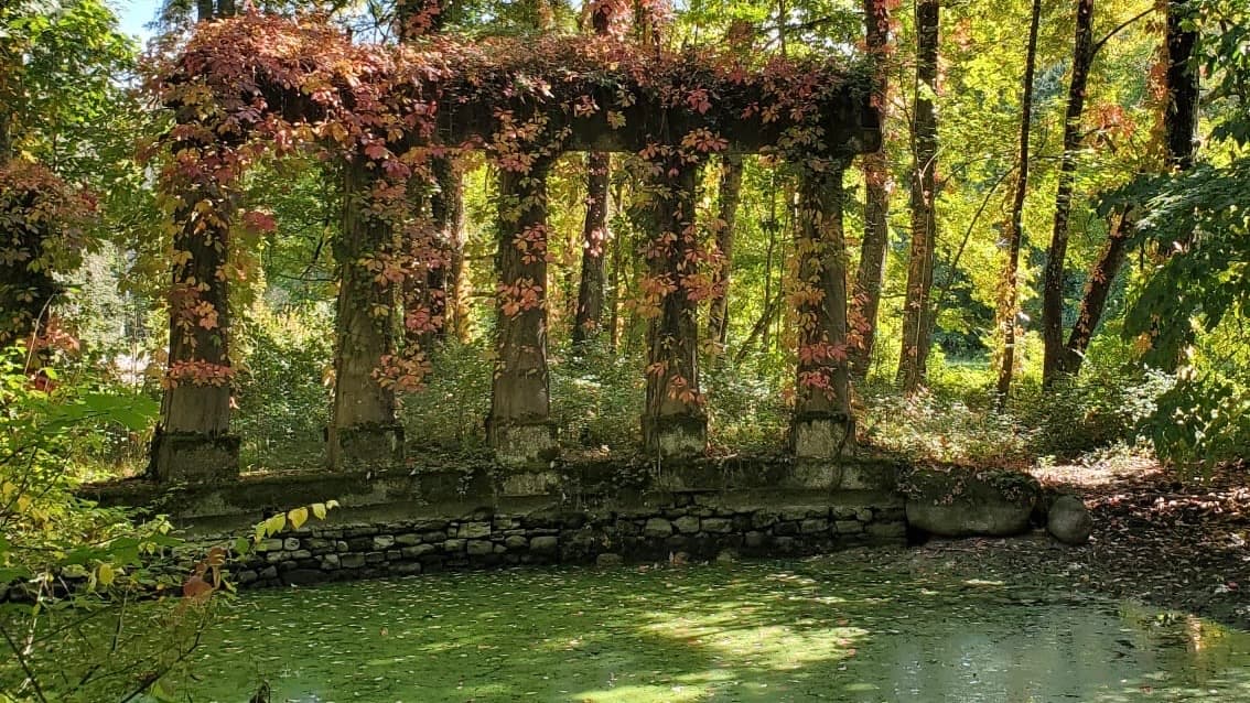 Ancient stone columns beside the castle lake