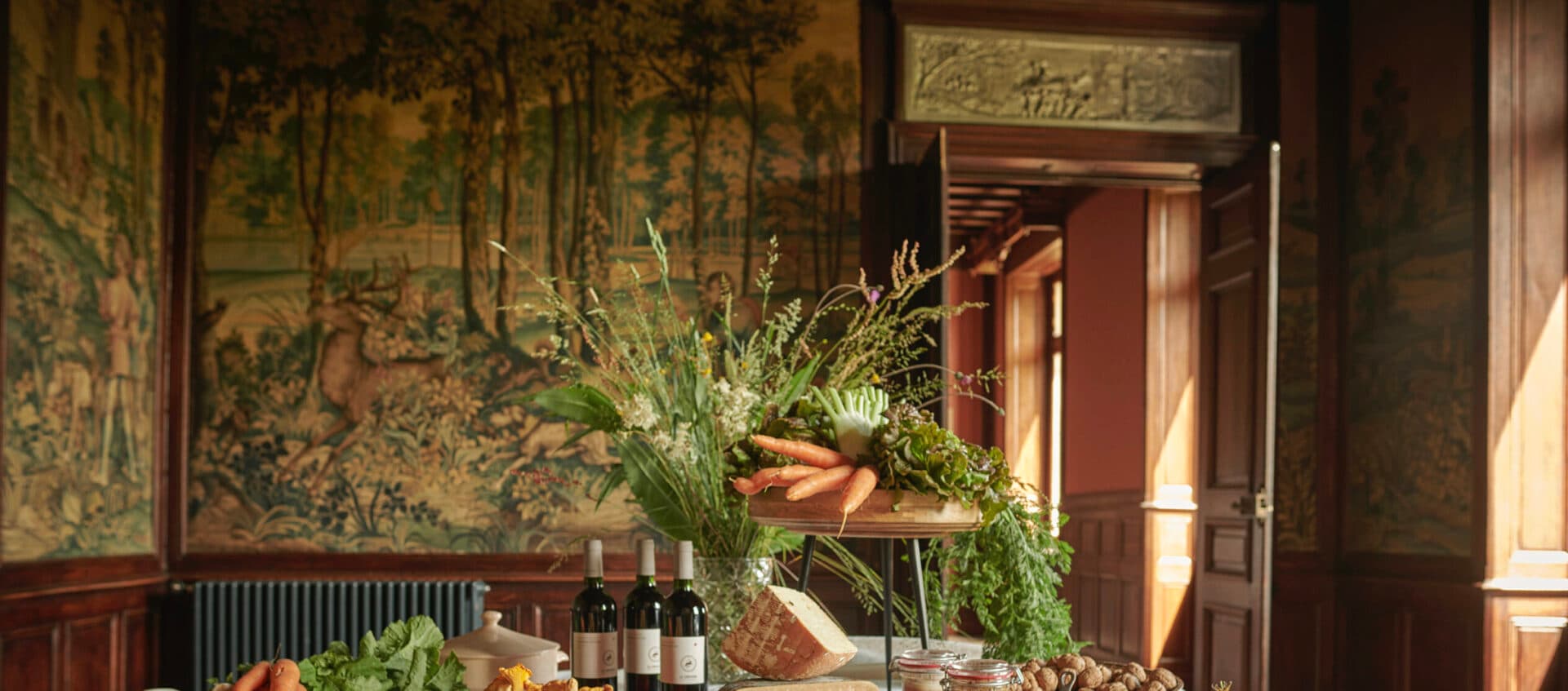 A long candle-lit feast table in the castle dining room